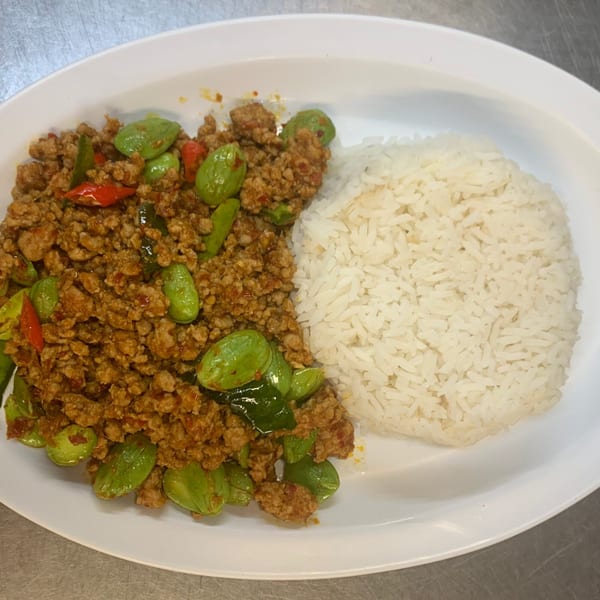 Thai stir-fried minced pork with stink beans and red chilies, served with white rice.